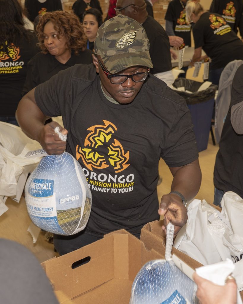 Volunteer Jason McFadden of Fountain of Life Temple Church in Banning helps package turkeys being donated by the Morongo Band of Mission Indians.